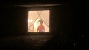 Voyeur watches sexy neighbor through window after shower